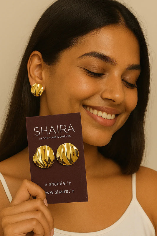 Model wearing Shaira Solis Wave Studs and holding earring card with logo, showcasing anti-tarnish gold jewelry with a radiant smile — perfect for everyday elegance.