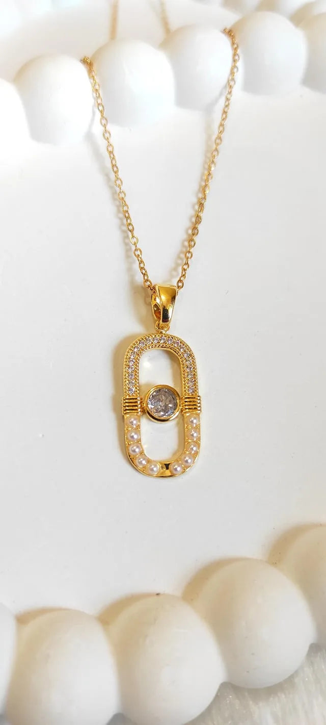 Gold necklace with a diamond pendant on a white background