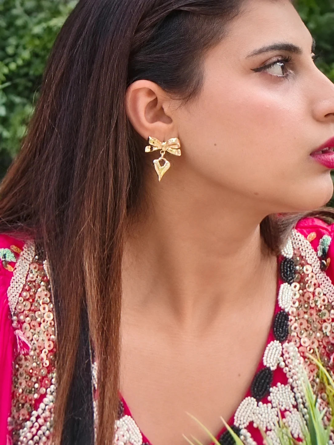 Farhana Bhatt wearing Shaira Jewelry’s Amora Bow Drop Earrings in gold, featuring a delicate bow design with a dangling heart-inspired drop.