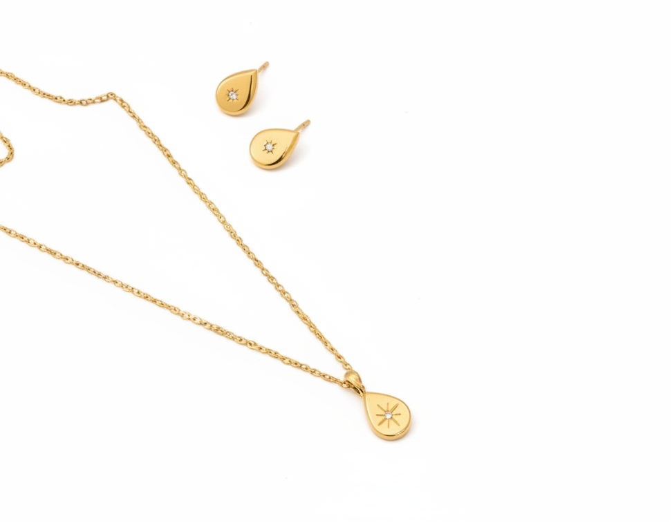 Gold necklace and earrings on a white background