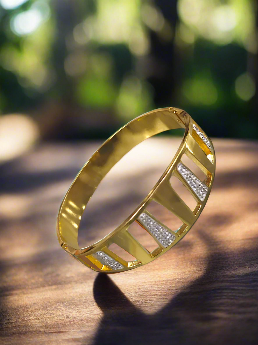 Gold bracelet with diamond accents on a marble surface