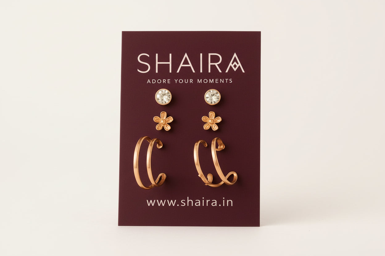 Shaira earrings on a branded card with a beige fabric background
