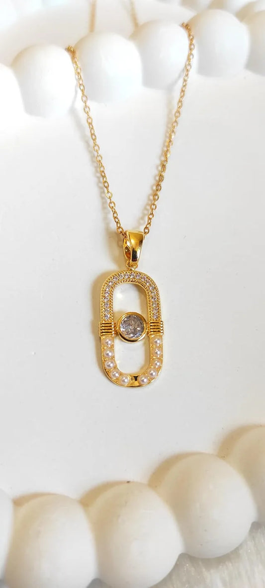 Gold necklace with a diamond pendant on a white background